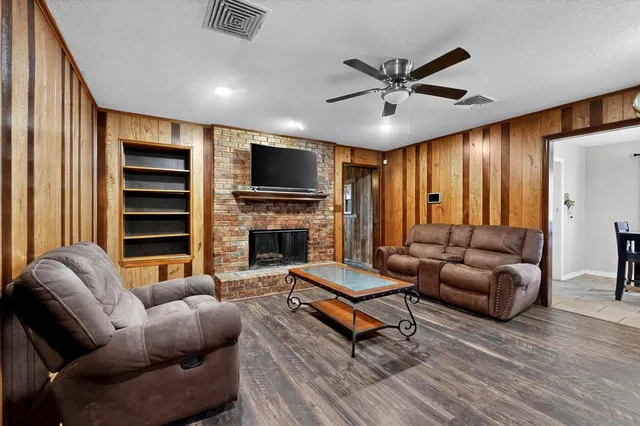 a living room with furniture a fireplace and a flat screen tv