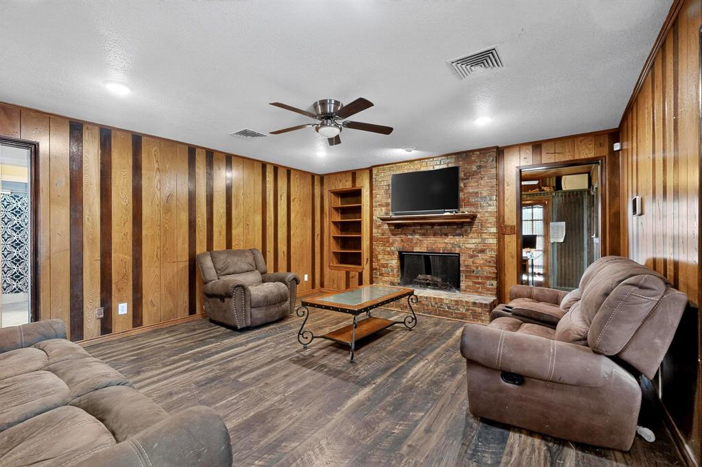 865 Harlan Road Combine, TX 75159 - Photo 8 of 38 a living room with furniture flat screen tv and a fireplace