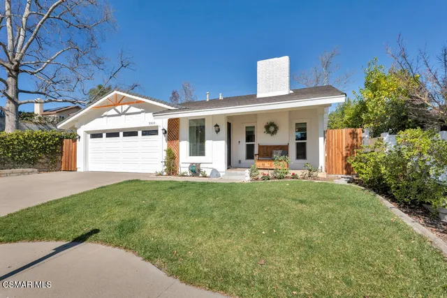 a front view of a house with yard patio and green space