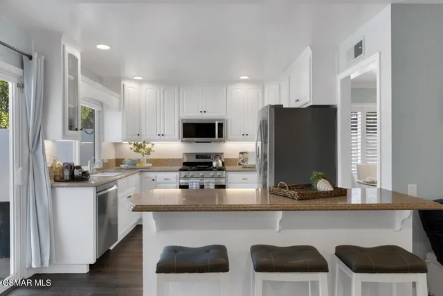 a bedroom with a bed a chair and a window