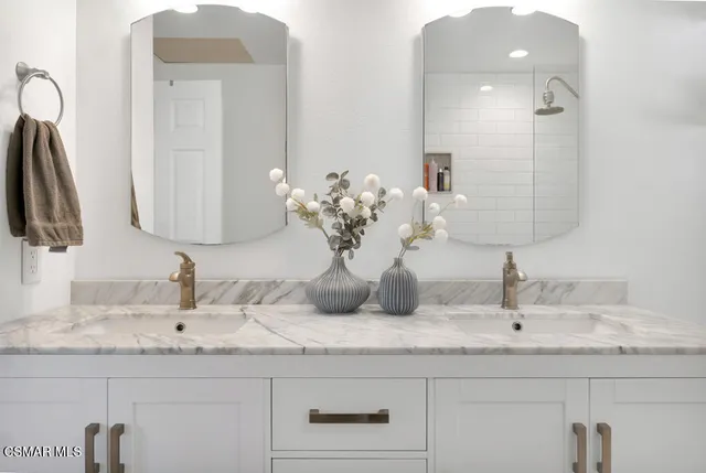 a bedroom with a bed and a tv on the dresser