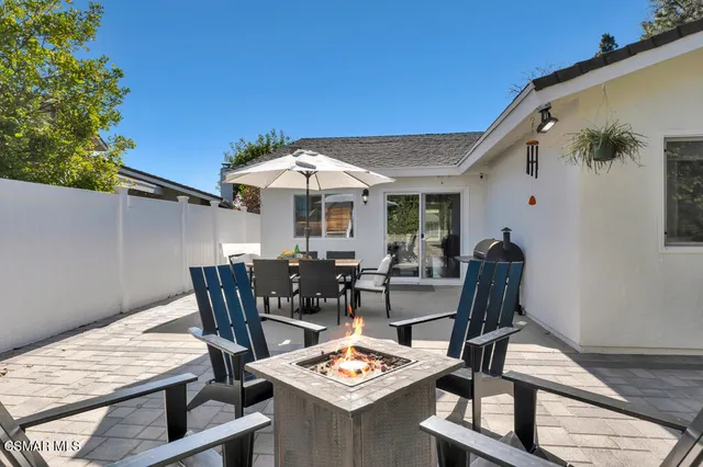 a view of a backyard with furniture and a table