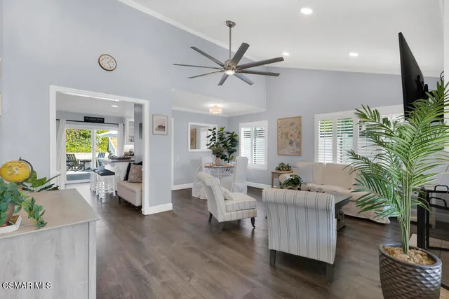 a dining room with furniture a fireplace and wooden floor