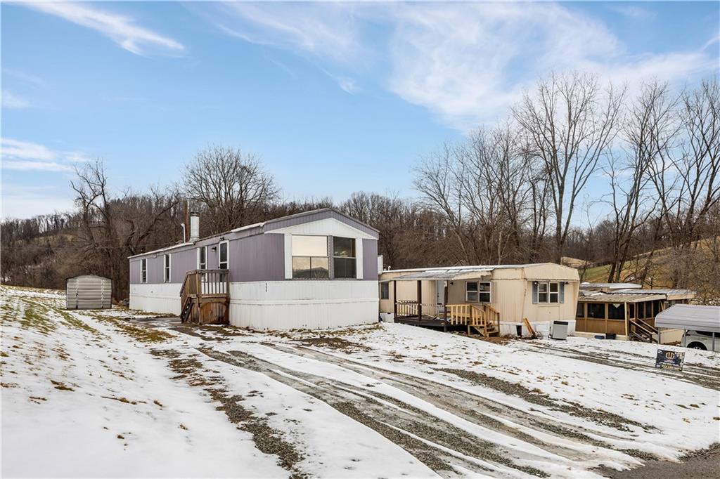 111 Dancer Lane Jeannette, PA 15644 - Photo 1 of 26 a view of a white house with a snow on the road