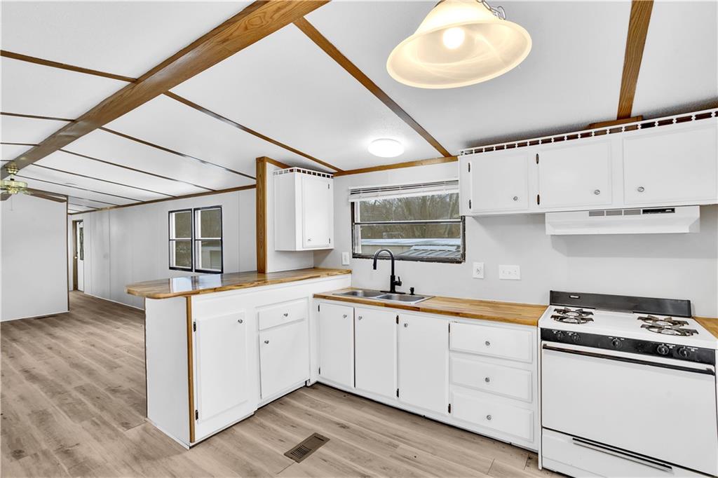 111 Dancer Lane Jeannette, PA 15644 - Photo 14 of 26 a kitchen with granite countertop a sink a stove and cabinets