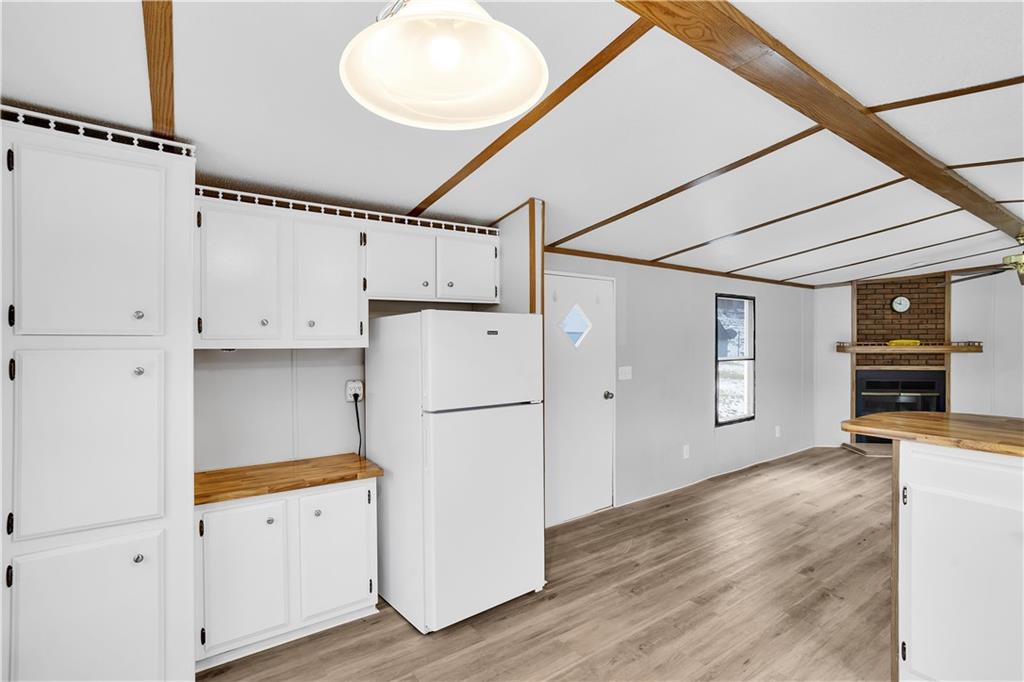 111 Dancer Lane Jeannette, PA 15644 - Photo 15 of 26 a view of a kitchen with refrigerator and wooden floor