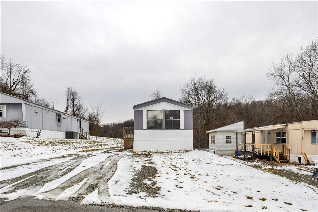 111 Dancer Lane Jeannette, PA 15644 - Photo 2 of 26 a front view of a house with a yard