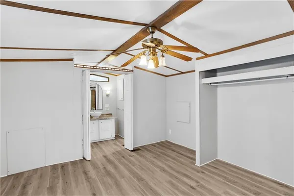 a view of a room with wooden floor