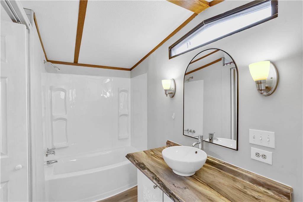 111 Dancer Lane Jeannette, PA 15644 - Photo 25 of 26 a bathroom with a granite countertop sink and a mirror