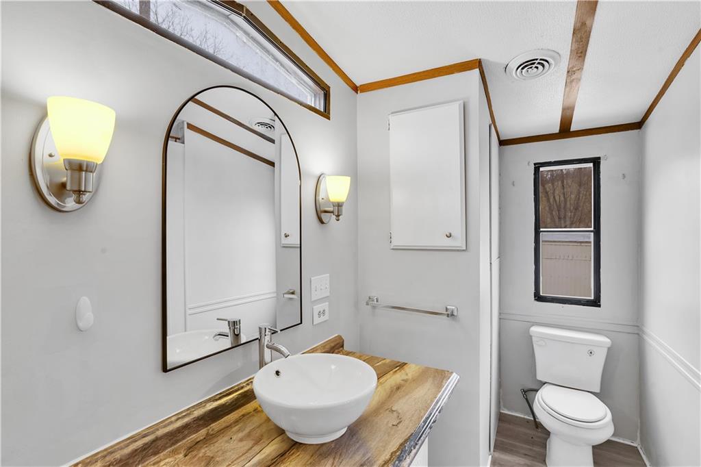 111 Dancer Lane Jeannette, PA 15644 - Photo 26 of 26 a bathroom with a toilet a sink and mirror