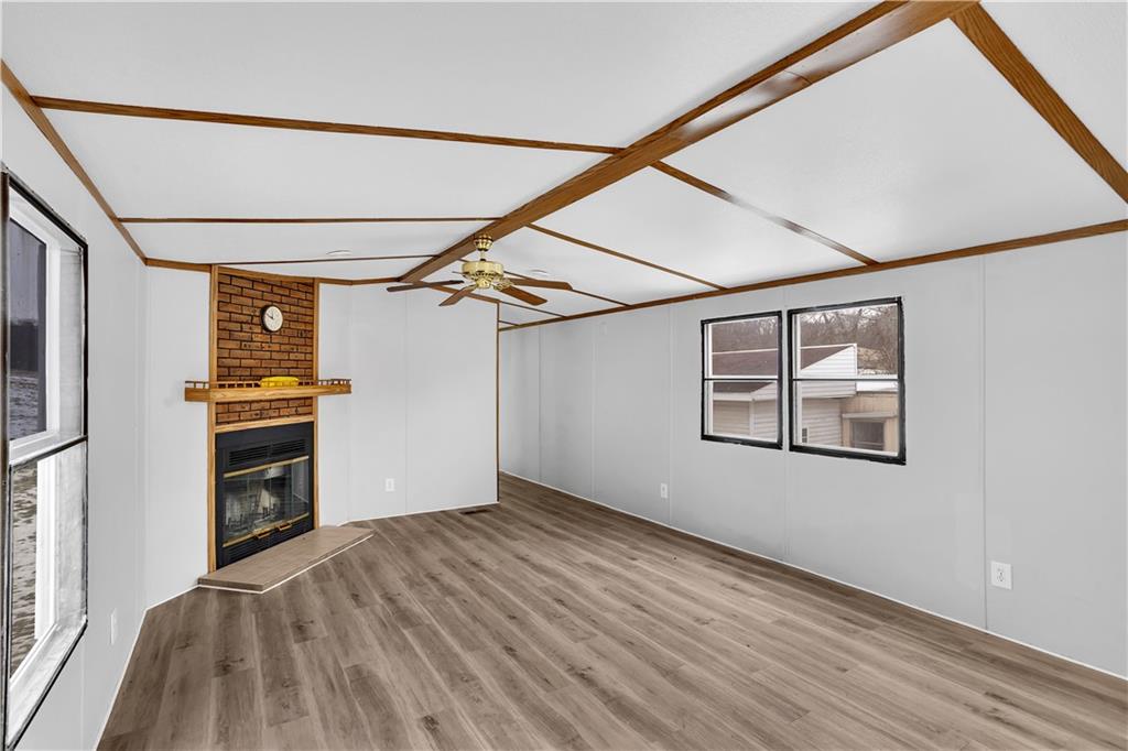 111 Dancer Lane Jeannette, PA 15644 - Photo 6 of 26 en empty room with wooden floor and windows