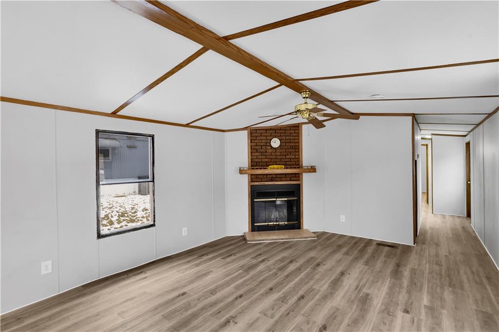 111 Dancer Lane Jeannette, PA 15644 - Photo 8 of 26 a view of empty room with wooden floor and fireplace