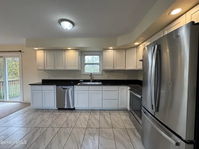 a kitchen with a refrigerator and a sink