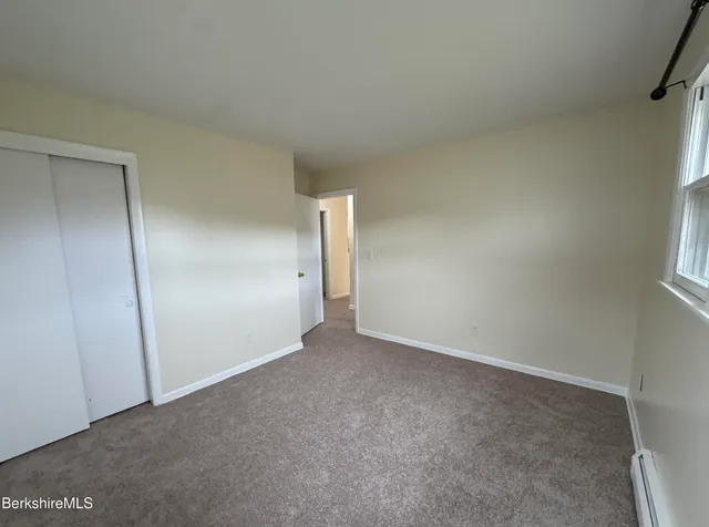 a view of an empty room and a window