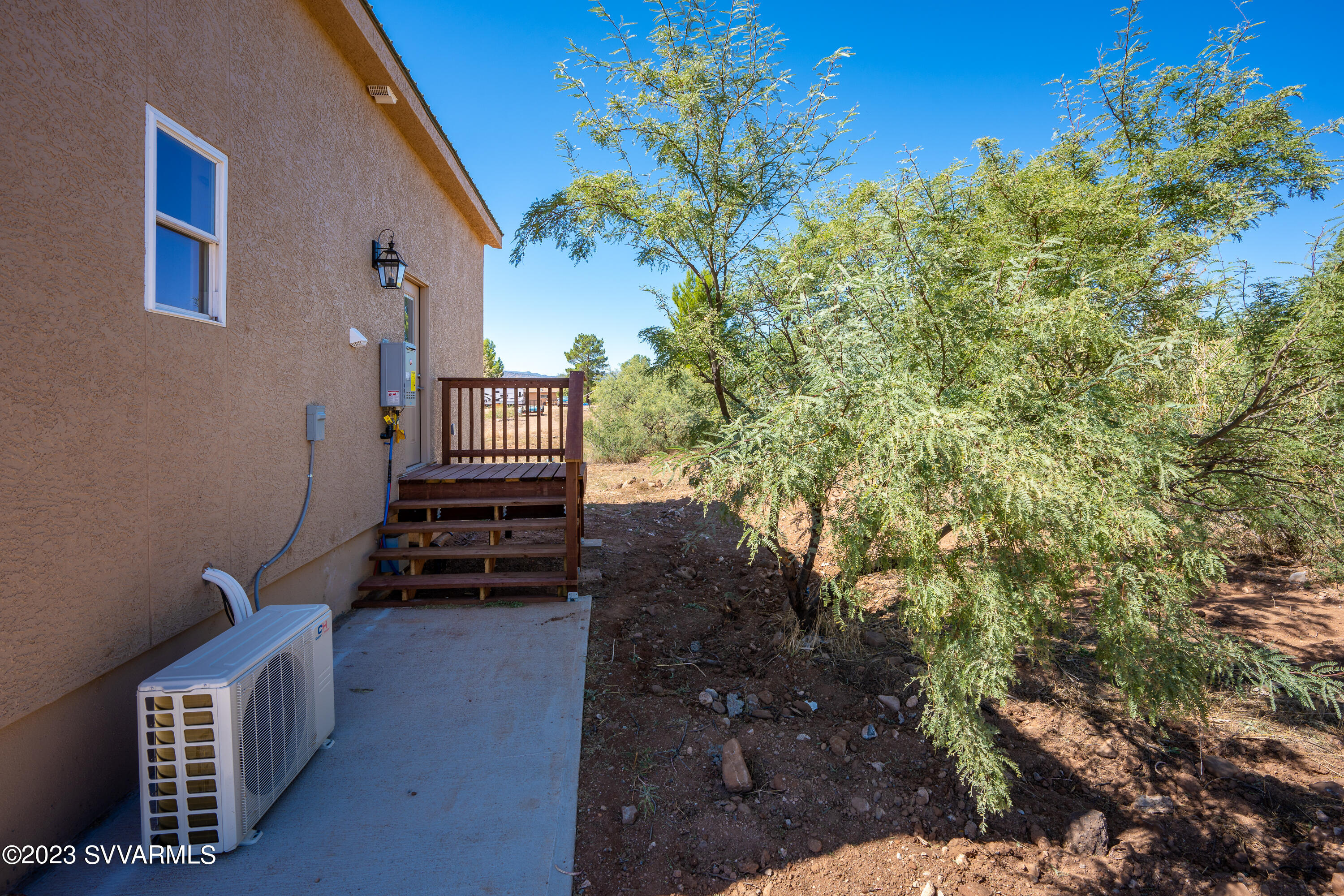 1652 Montezuma Heights Road Camp Verde, AZ 86322 - Photo 3 of 29 a view of a backyard with plants and brick wall