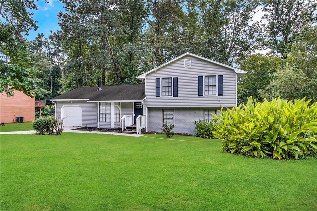 a front view of a house with a yard and garage