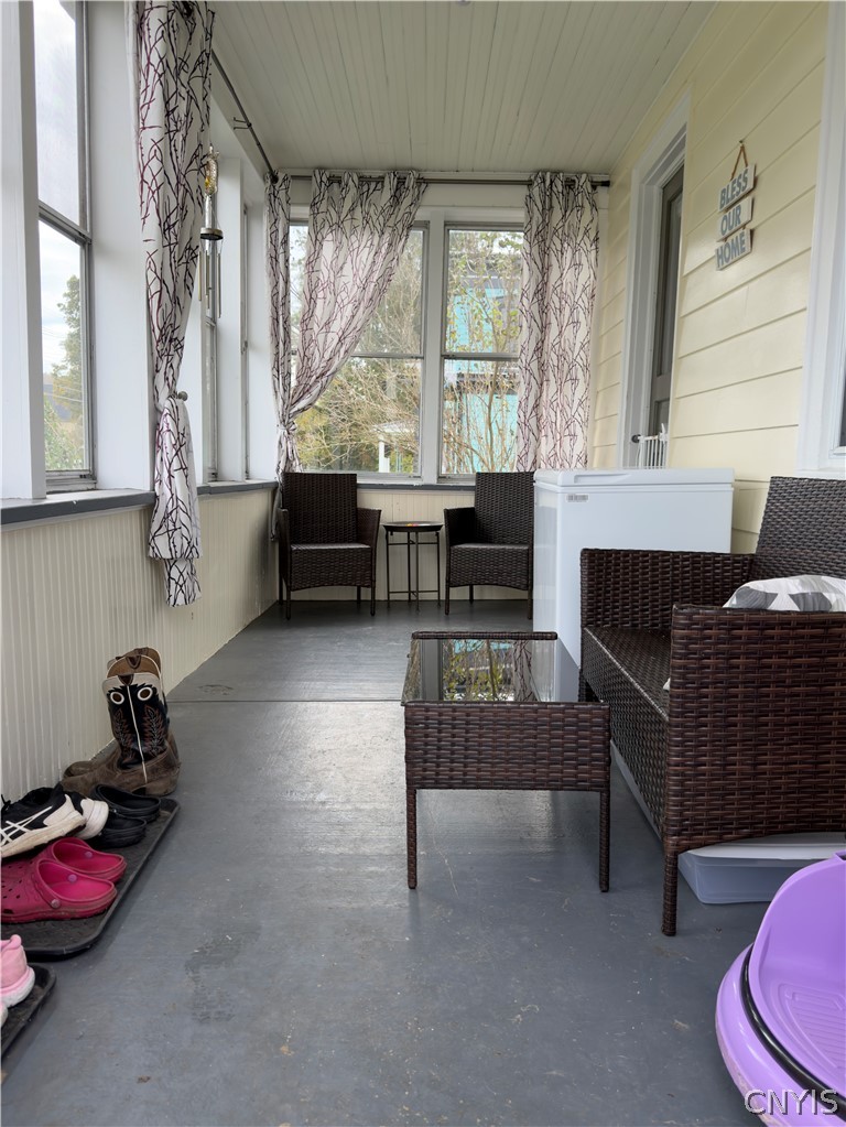 7468 Willey Road Hamilton, NY 13332 - Photo 4 of 19 An inviting enclosed porch features classic beadboard walls and a painted floor.