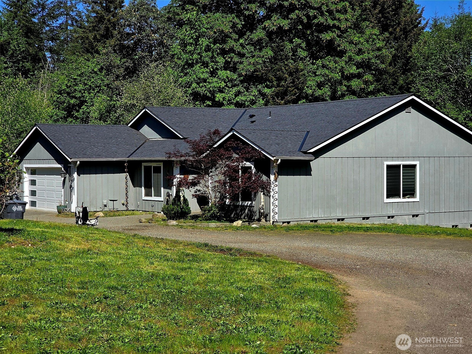 6611 Crescent Beach Road Northwest Vaughn, WA 98394 - Photo 15 of 17 a view of a house with backyard and trees