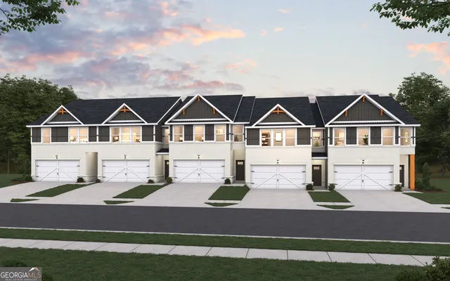 a view of a white house next to a yard