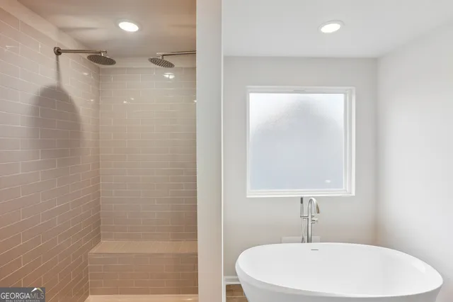 a bathroom with a bathtub and shower