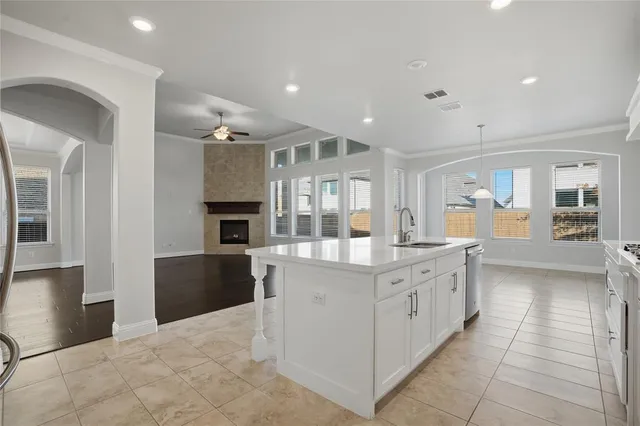 a large kitchen with stainless steel appliances kitchen island granite countertop a large counter top and a stove