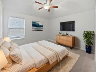 a bedroom with a bed and a television