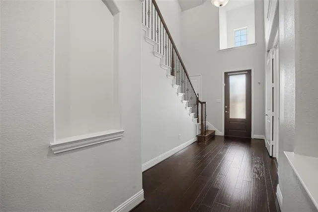 a view of an entryway with wooden floor