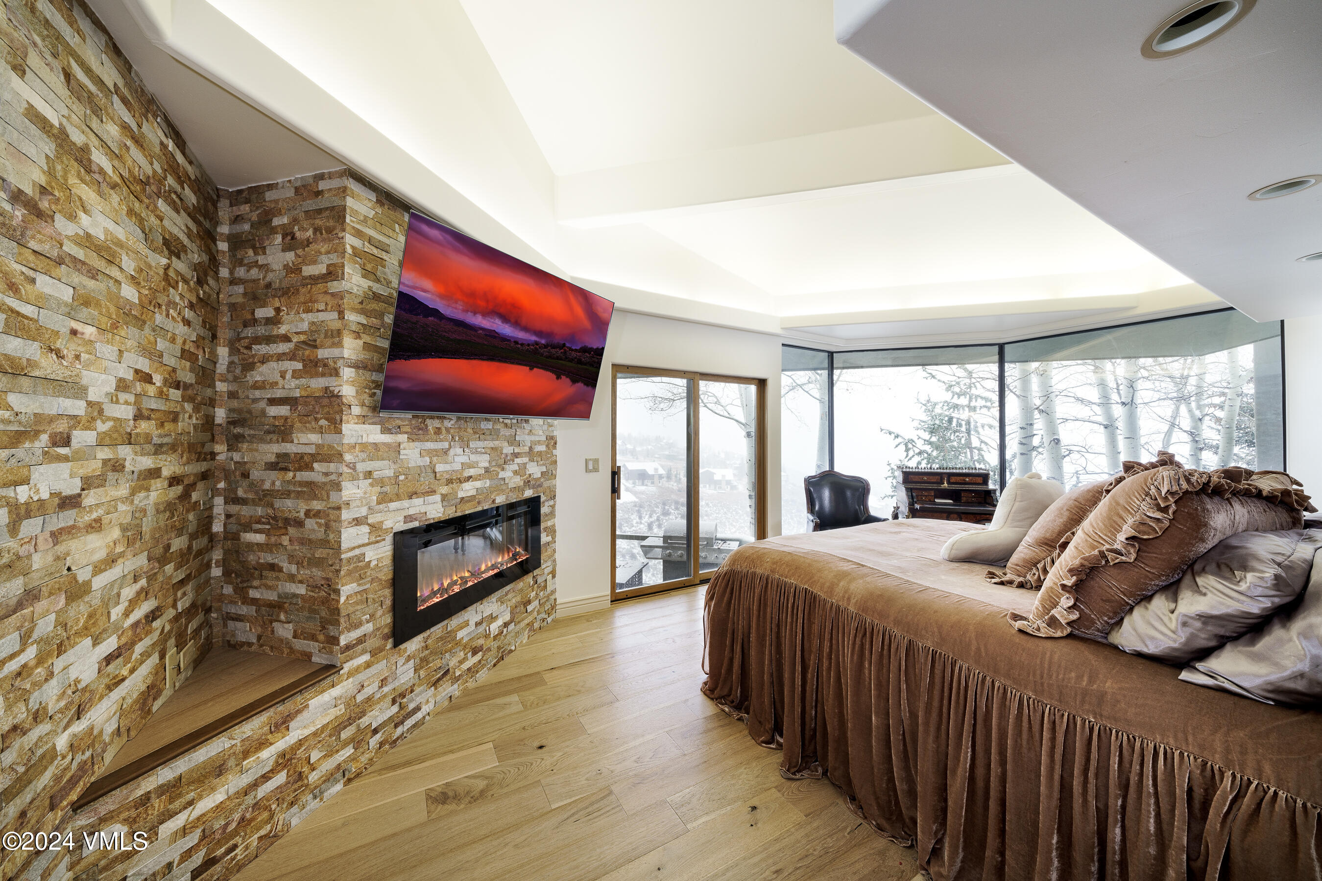 4747 Wildridge Road Avon, CO 81620 - Photo 12 of 51 a bedroom with a bed and a fireplace