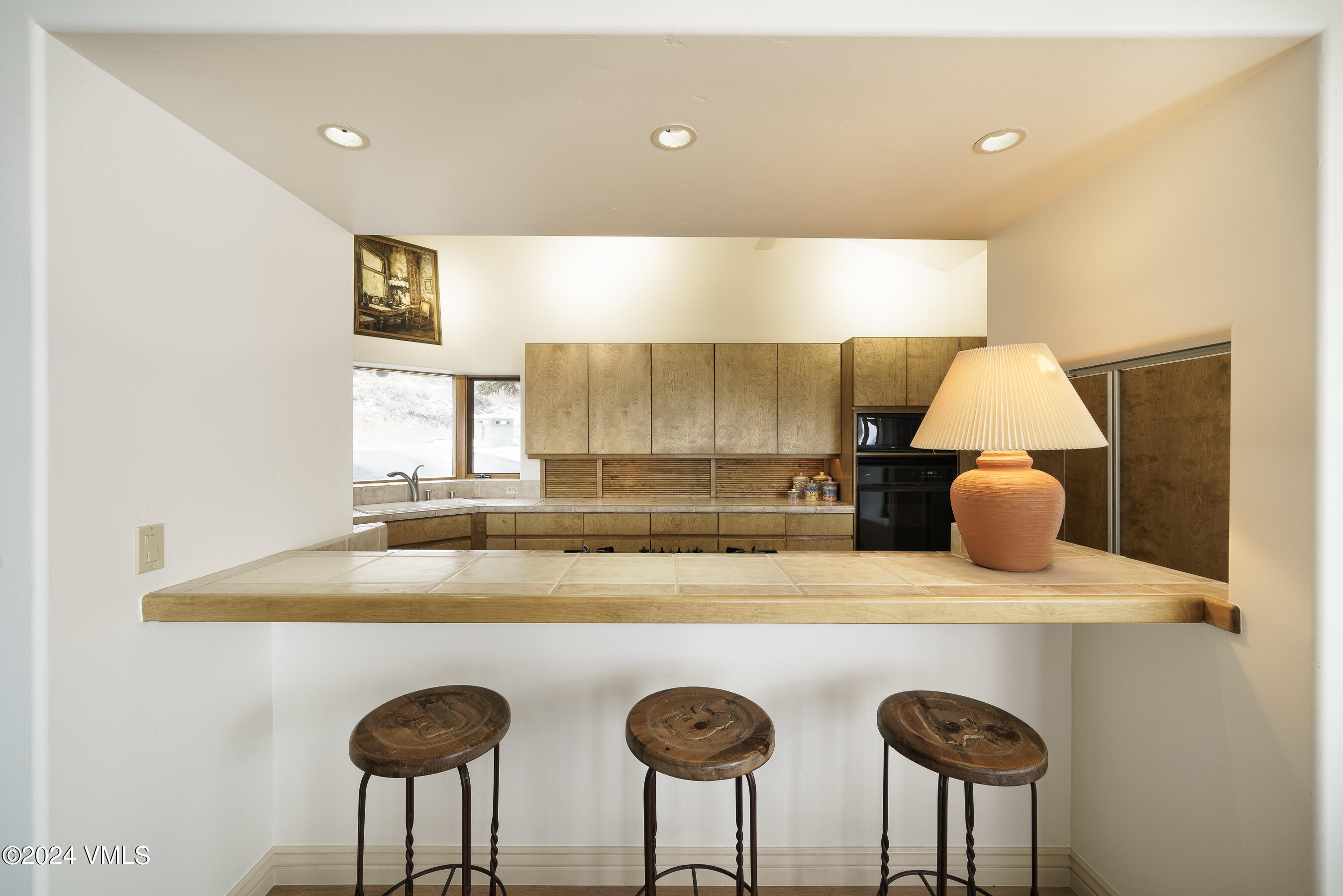 4747 Wildridge Road Avon, CO 81620 - Photo 25 of 51 a kitchen with a table a sink and a stove