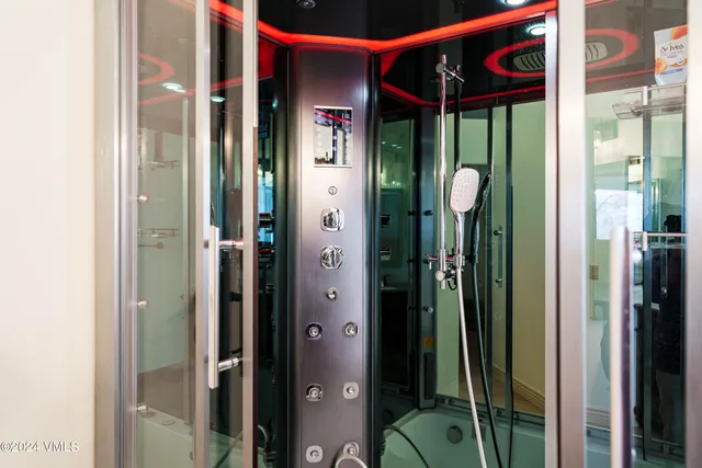 a spacious bathroom with a shower sink and mirror