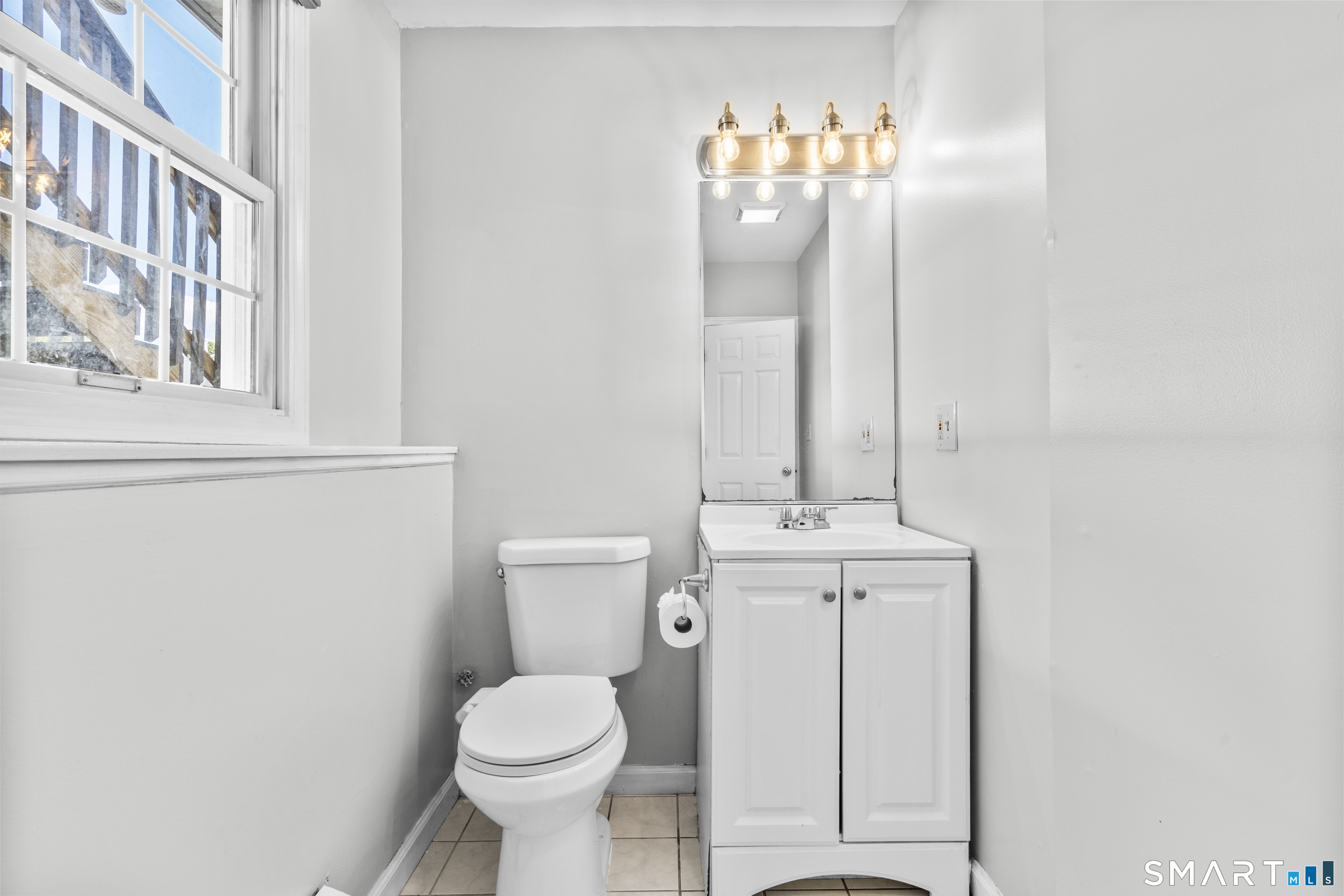 39 Joseph Lane Hamden, CT 06514 - Photo 30 of 40 a bathroom with a toilet sink and mirror