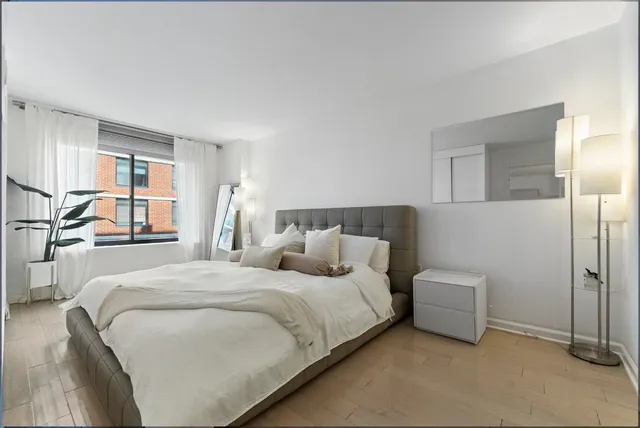 a bedroom with double bed and a window