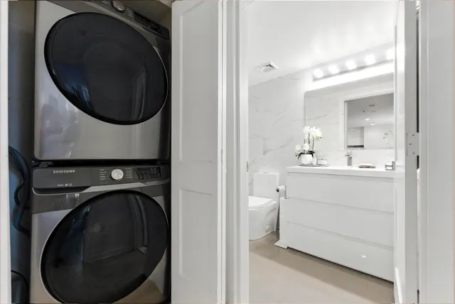a utility room with sink dryer and washer