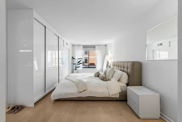 a bedroom with a bed couch and a window