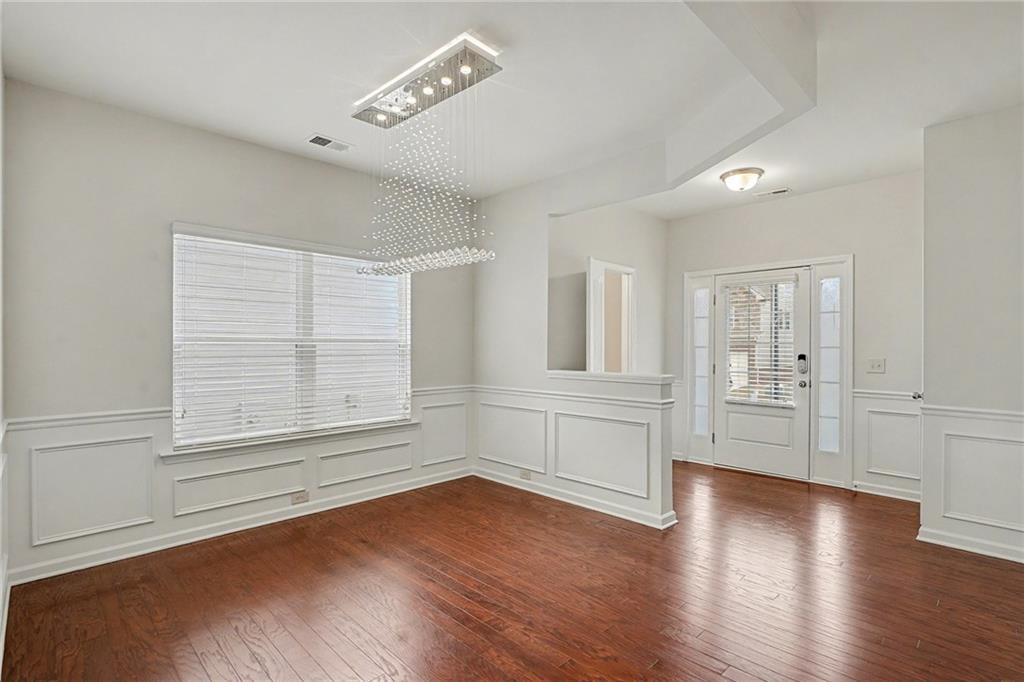 321 Lara Lane Hampton, GA 30228 - Photo 11 of 33 an empty room with wooden floor and windows