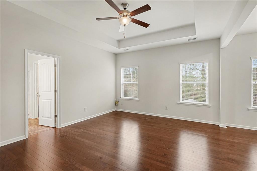 321 Lara Lane Hampton, GA 30228 - Photo 13 of 33 a view of empty room with wooden floor and fan