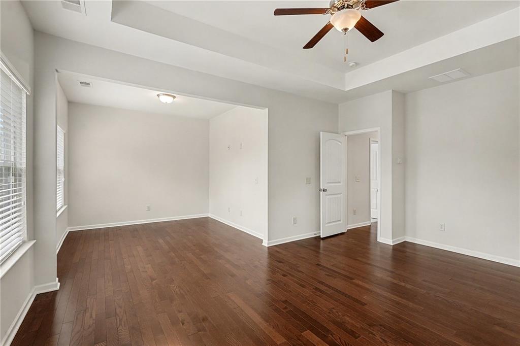 321 Lara Lane Hampton, GA 30228 - Photo 14 of 33 wooden floor in an empty room with a window