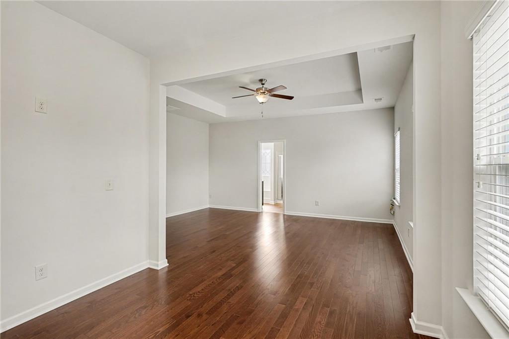 321 Lara Lane Hampton, GA 30228 - Photo 15 of 33 an empty room with wooden floor and windows