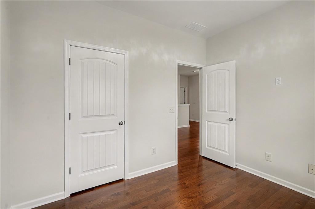 321 Lara Lane Hampton, GA 30228 - Photo 18 of 33 a view of an empty room and wooden floor