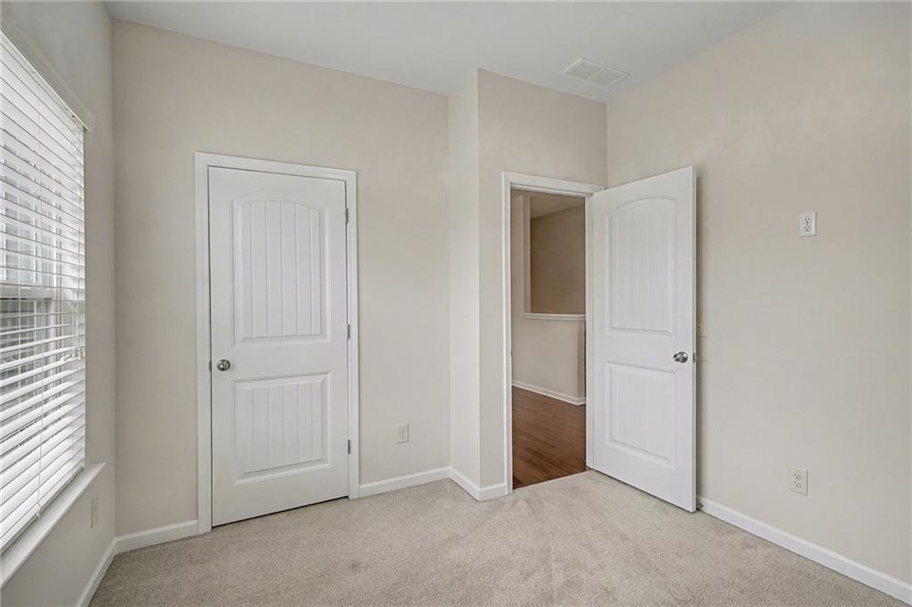 321 Lara Lane Hampton, GA 30228 - Photo 19 of 33 an empty room with windows and closet