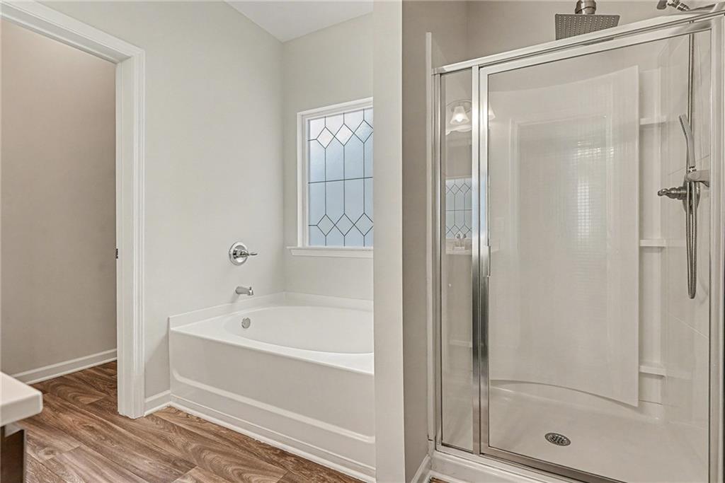 321 Lara Lane Hampton, GA 30228 - Photo 23 of 33 a bathroom with a bathtub and a shower