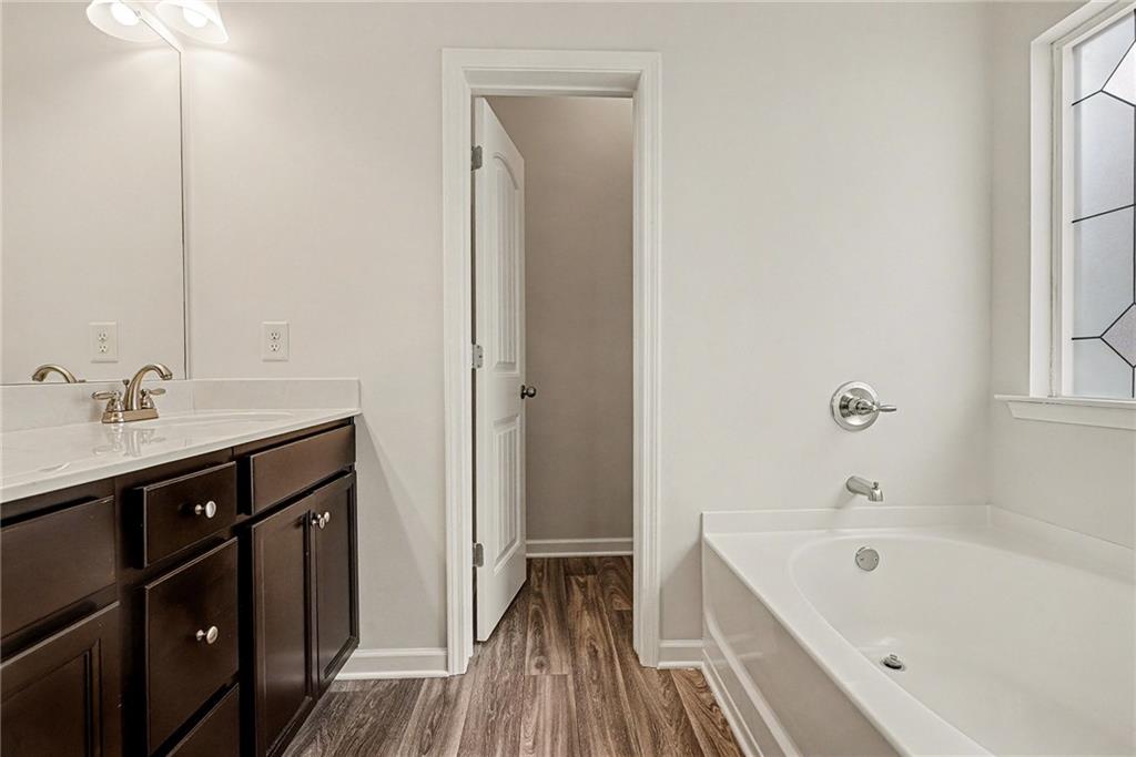 321 Lara Lane Hampton, GA 30228 - Photo 24 of 33 a bathroom with a tub sink and mirror