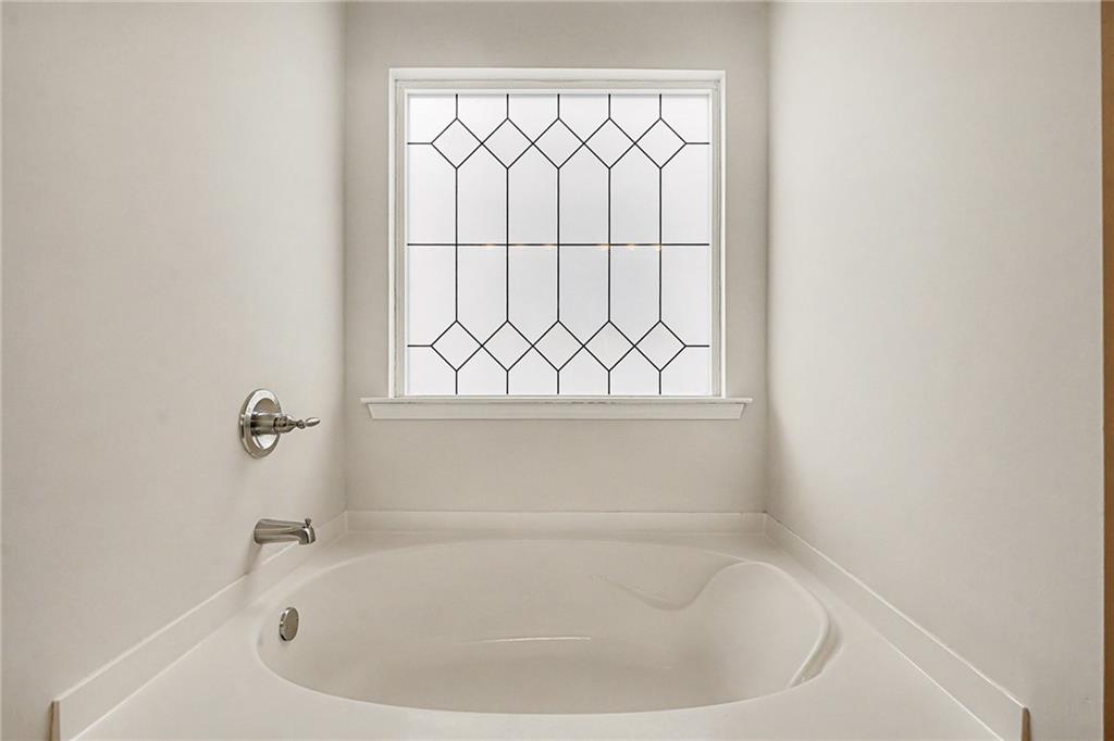 321 Lara Lane Hampton, GA 30228 - Photo 26 of 33 a white bath tub sitting next to a window