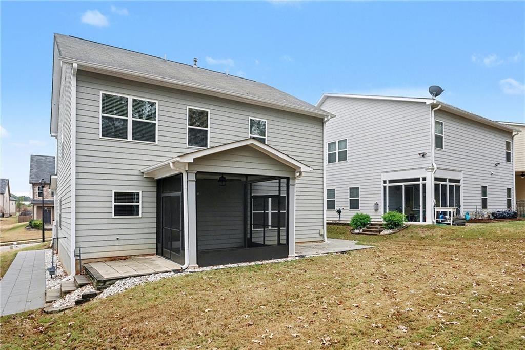 321 Lara Lane Hampton, GA 30228 - Photo 32 of 33 a front view of a house with a yard