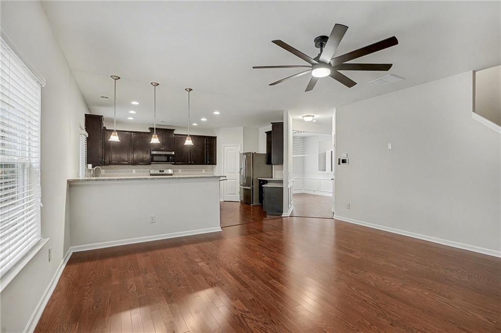 321 Lara Lane Hampton, GA 30228 - Photo 6 of 33 a view of a kitchen with a microwave and a ceiling fan