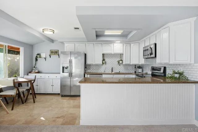 a kitchen with granite countertop a stove sink and cabinets