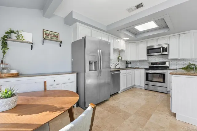 a bathroom with a granite countertop toilet sink and mirror