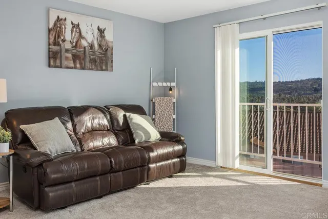 a living room with furniture and kitchen view