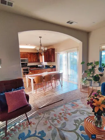 a living room with furniture and a open kitchen area