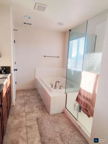 a bathroom with a tub sink and mirror
